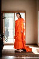 Stunning Orange Long Trail Gown with Waist Drape, Intricate Ruffle Work, Square Neckline & Full Sleeves