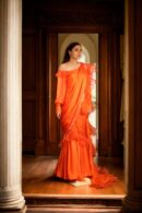 Stunning Orange Long Trail Gown with Waist Drape, Intricate Ruffle Work, Square Neckline & Full Sleeves