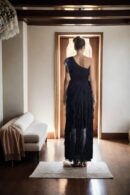 Black Net One-Shoulder Gown with Stretch Design, Ruffled Draped Detailing, and Front Slit - Elegant Evening Wear
